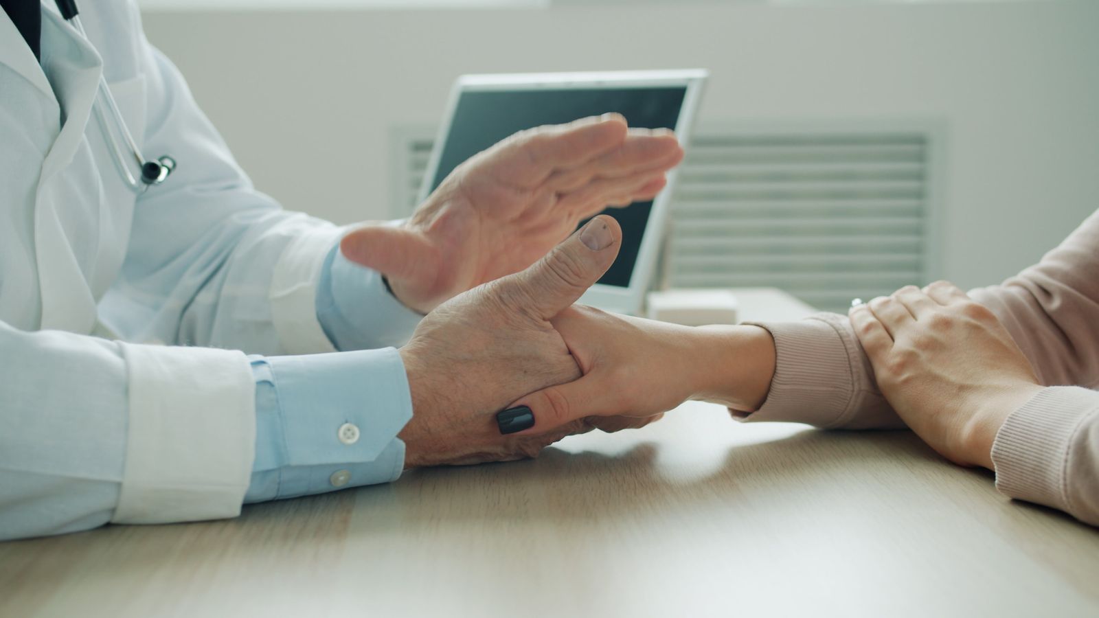 Doctor examining a patient's wrist
